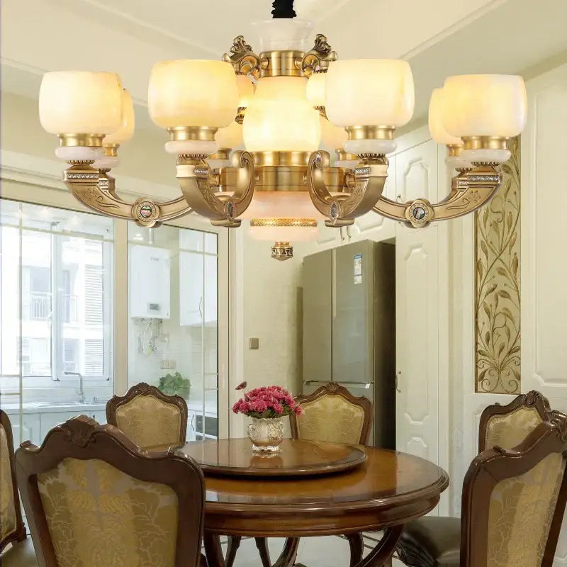 Gold-toned decorbites jade chandelier lighting fixture with frosted glass shades and ornate all-copper metalwork