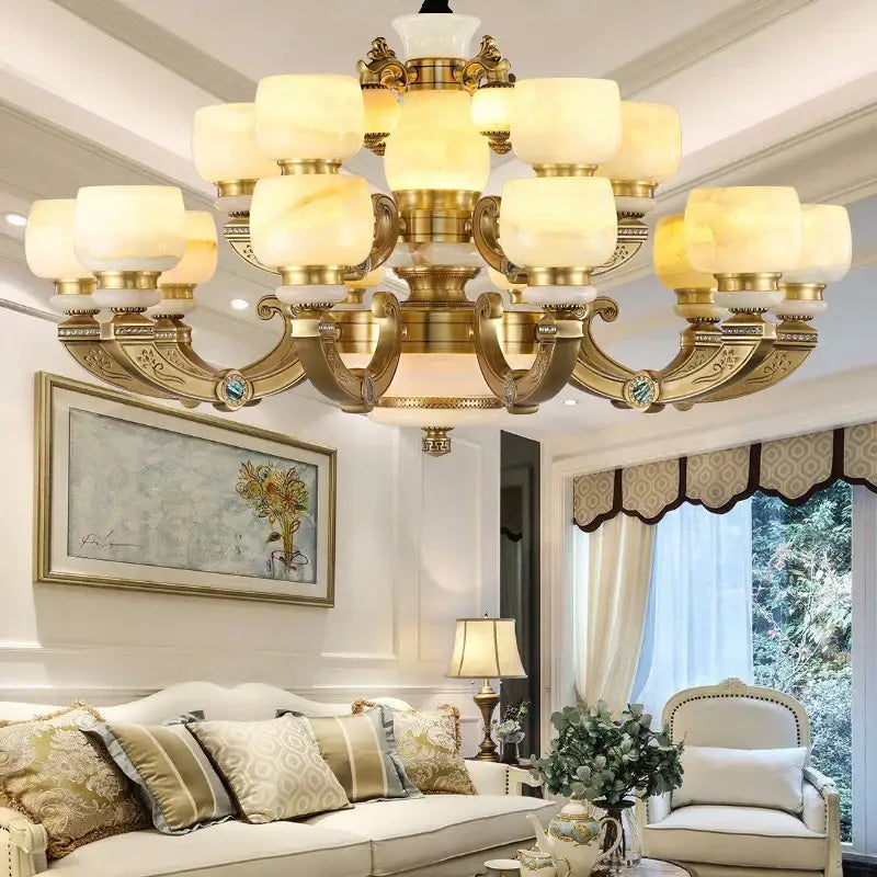 Gold-toned decorbites jade chandelier lighting fixture with frosted warm-lit glass shades and ornate metal arms