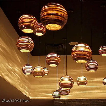 Warm-toned spherical pendant lights with concentric striped patterns made of woven cardboard by DecorBites pendant lights
