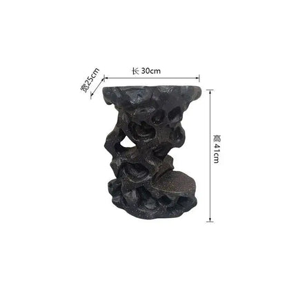 Black intricately carved resin garden stool with rugged design for modern minimalist living room decor by DecorBites