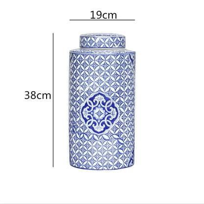 A tall porcelain decorbites chinese retro tea canister with blue and white geometric patterns and a matching lid