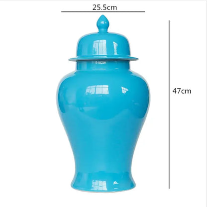 A glossy turquoise ceramic general jar vase with matching lid and decorative finial for home decor and storage