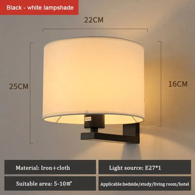 DecorBites™ modern black iron wall lamp with cylindrical white cloth covered wall lampshade for bedroom and living room