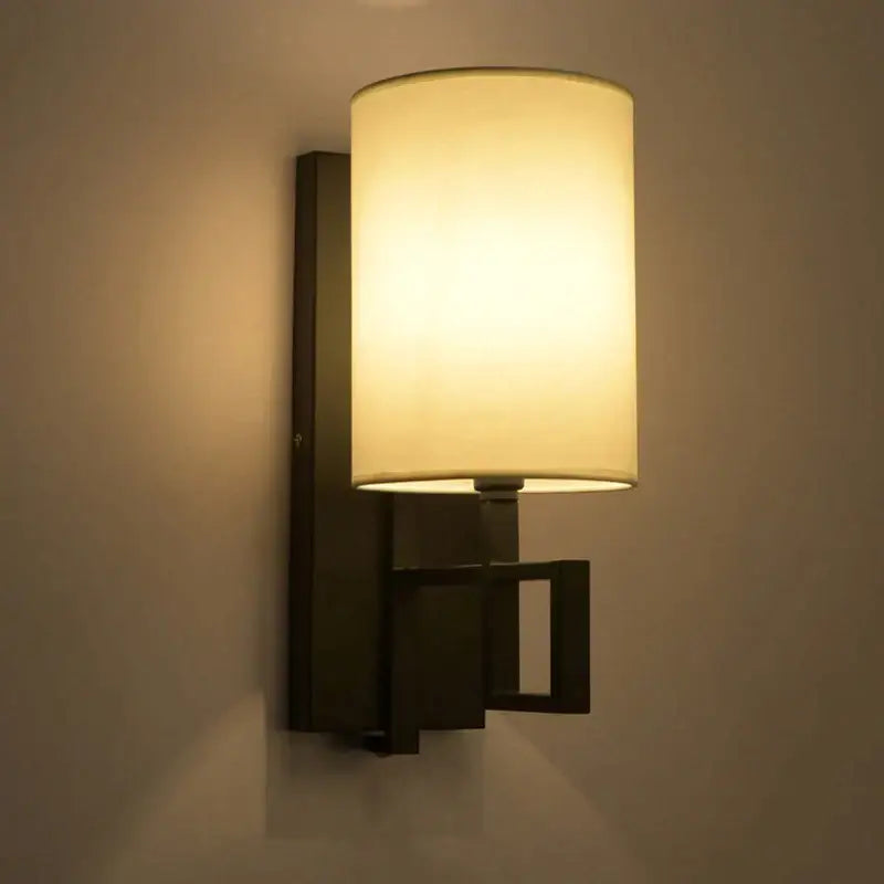 Decorbites™ warm-toned style cloth wall lamp with cylindrical shade and dark metal geometric frame for indoor use