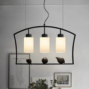 Black metal pendant ceiling lamp with three frosted glass cylinders and bird decor for cylinder island light fixture
