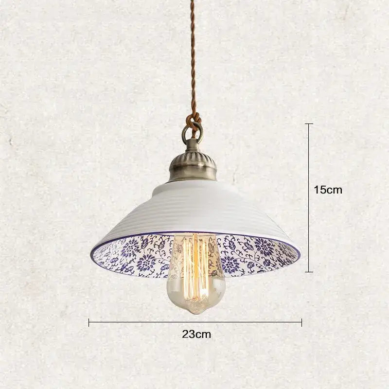 White ceramic hanging lamp with blue floral pattern inside, brass top, and exposed bulb by DecorBites Chinese style porcelain