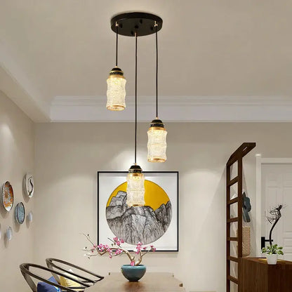 Three pendant lights with textured glass and black metal fixtures in decorbites™ spiral staircase chandelier for villa use