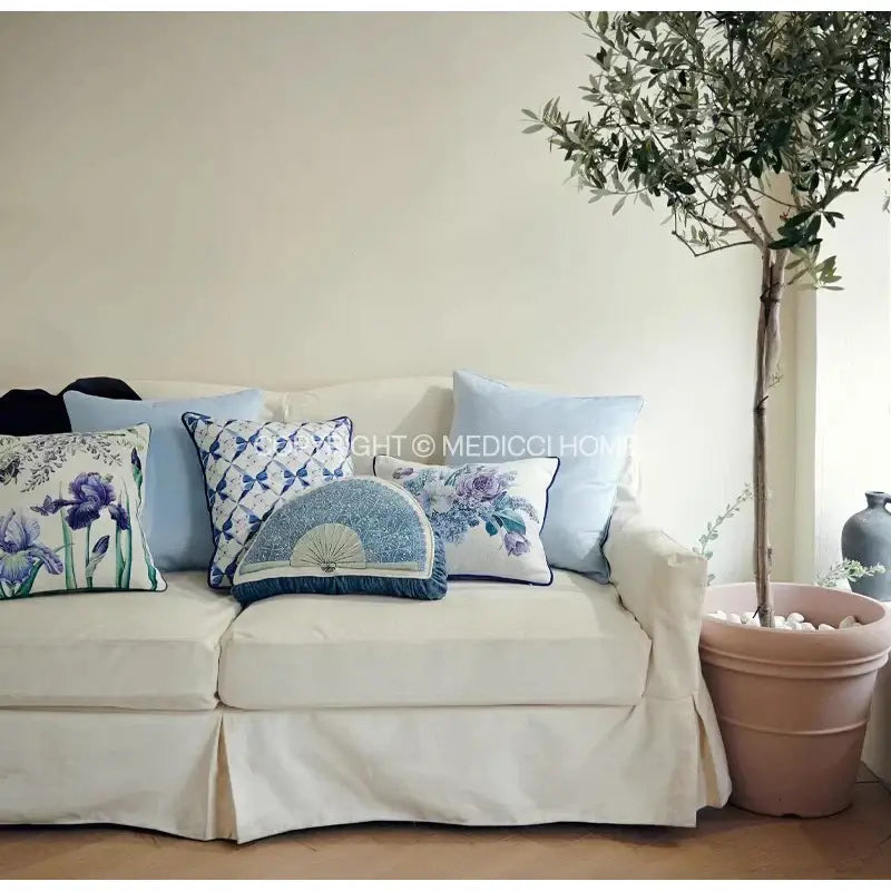Cream-colored sofa with decorbites chinoiserie blue wavy fan lumbar cushion cover featuring blue purple floral patterns