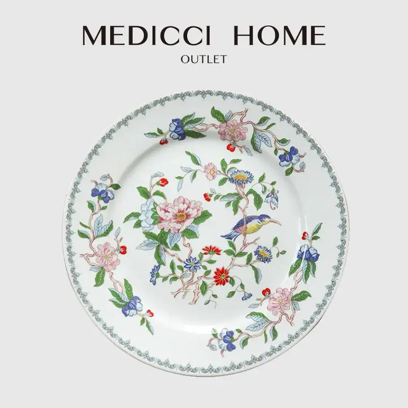 A delicate white porcelain decorbites chinoiserie floral birds dinner plate with vibrant pink blue red and green motifs