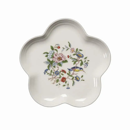 A delicate white ceramic decorbites chinoiserie floral birds dinner plate with hand-painted pink blue blossoms and green leaves