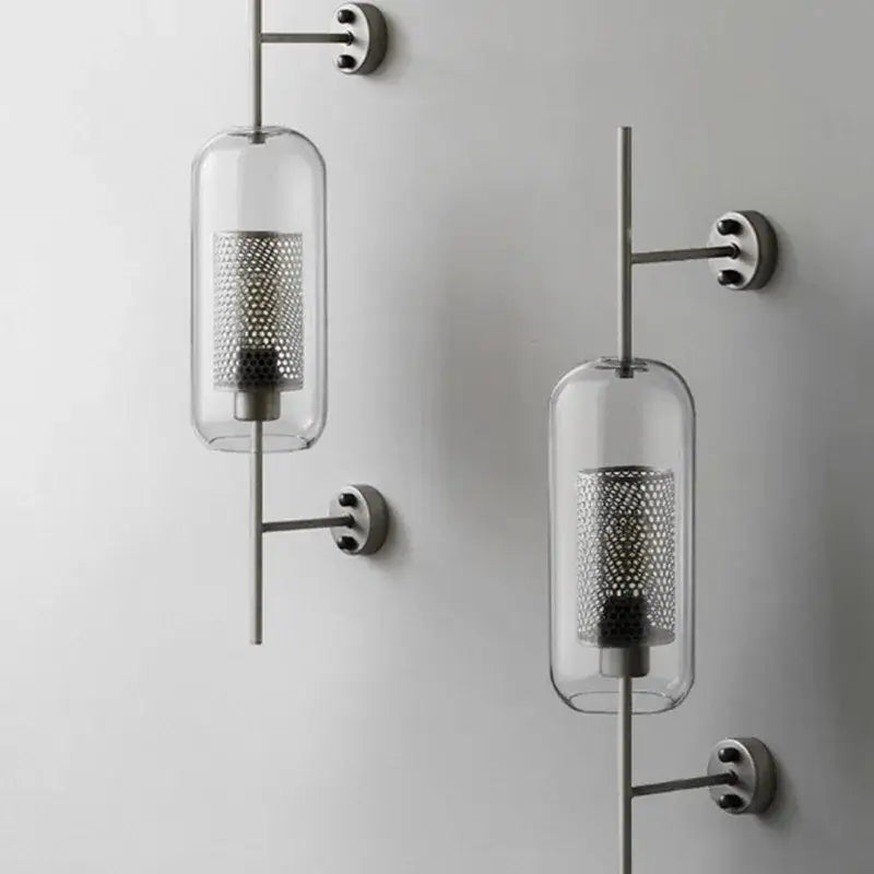 Modern minimalist chiswick glass wall light sconce with clear glass cylindrical shades and perforated metal mesh interiors
