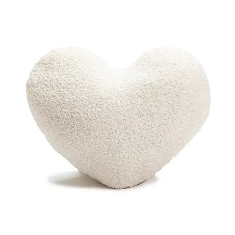 Cream-colored plush heart-shaped cushion with soft textured surface from decorbites christmas candy cushions collection
