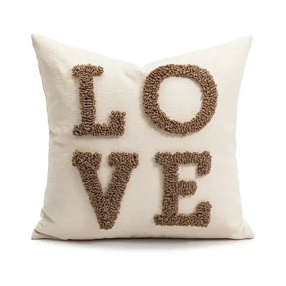 Cream-colored decorbites christmas candy cushion with textured brown yarn letters spelling love for festive sofa decor