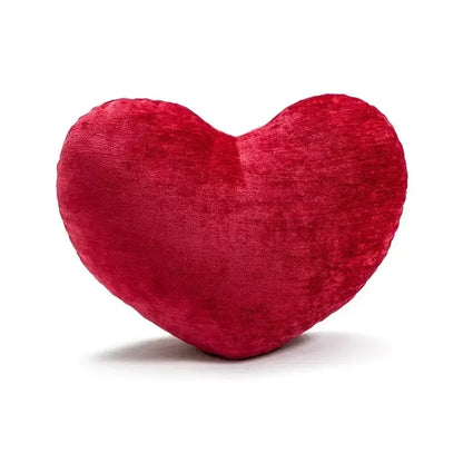 A plush vibrant red heart-shaped velvet cushion from decorbites christmas candy cushions for festive sofa decor