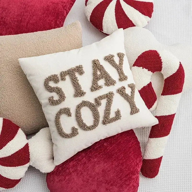White square cushion cover with stay cozy embroidered in textured brown yarn from decorbites christmas cartoon candy collection