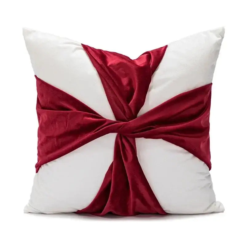 White cushion cover with burgundy velvet ribbon in an elegant crossbow knot for DecorBites Christmas cartoon candy design