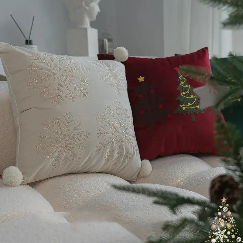 Cream-colored velvet pillow cover with embroidered silver snowflakes and white pom-poms decorbites christmas cartoon festive decor