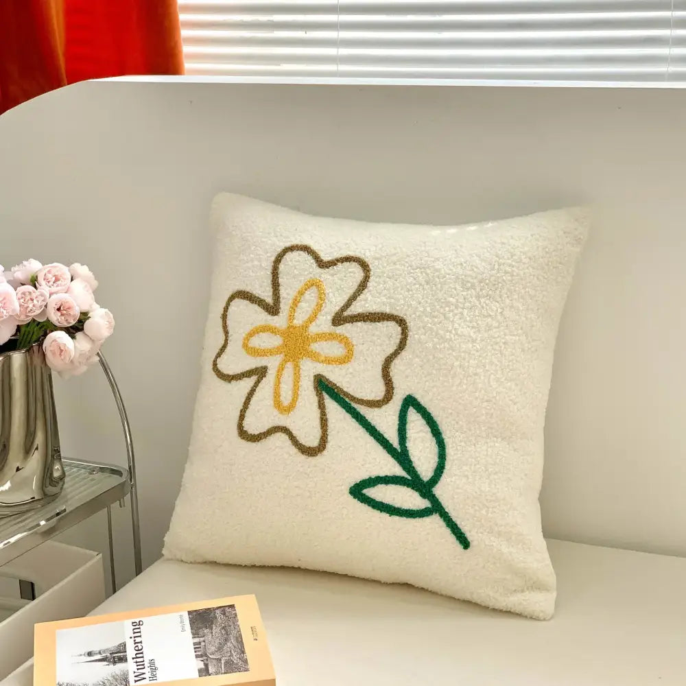 Cream-colored fluffy embroidered pillow with yellow flower design from decorbites christmas cartoon festive cushion set