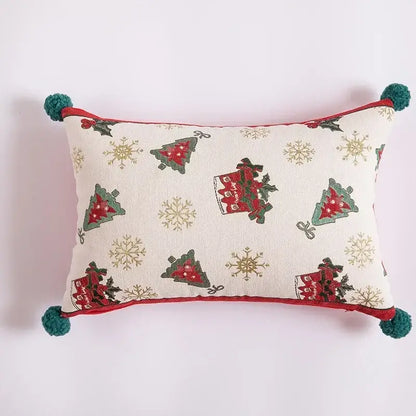 Cream-colored table runner with embroidered tassel, red and green christmas trees, gold snowflakes, and teal pom-poms for dining room decor