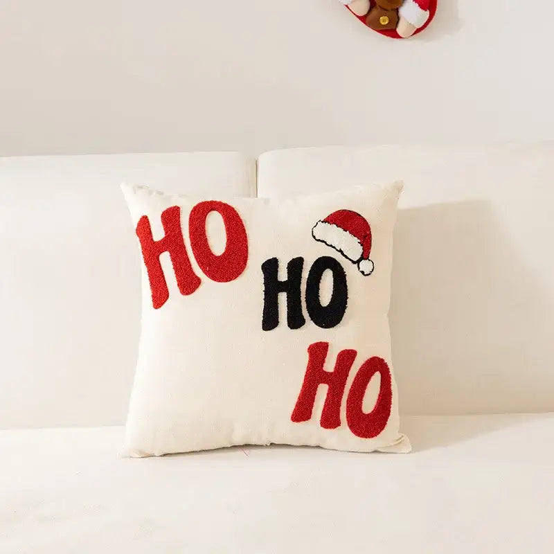 White pillow cover with embroidered ho ho ho letters and santa hat design from decorbites christmas cartoon collection