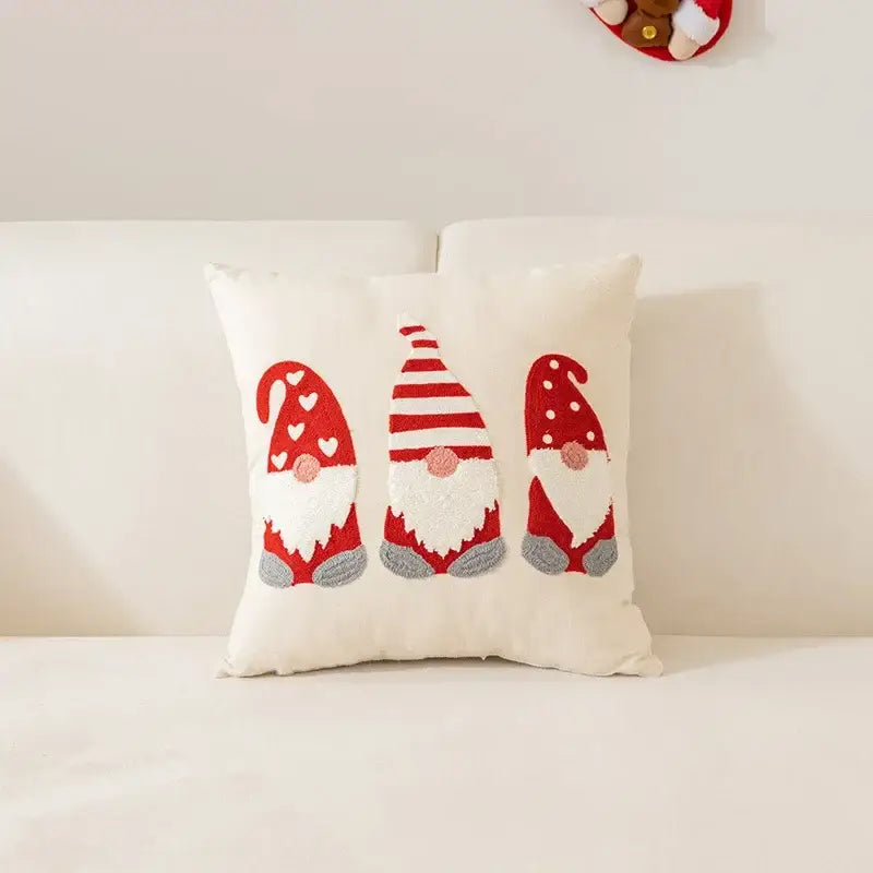Cream-colored pillow cover with three embroidered gnomes in red hats from decorbites christmas cartoon letter collection