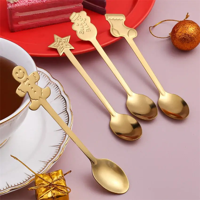 Set of four gold-finished stainless steel christmas coffee spoons with festive gingerbread man snowman star and bell handles