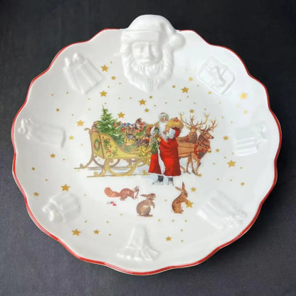 White ceramic christmas plate with red rim embossed santa face and santa sleigh illustration in decorbites christmas dinnerware set