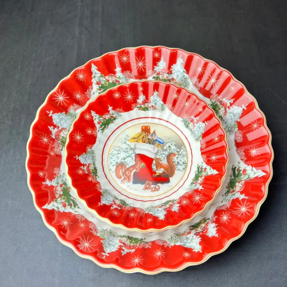 Set of three red ceramic plates with scalloped edges and festive illustrations from decorbites christmas dinnerware set