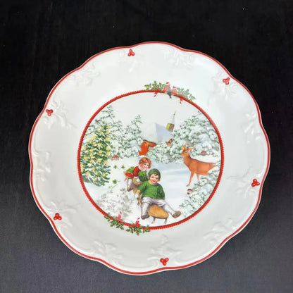 White ceramic christmas plate with red scalloped edge and sledding children scene for decorbites christmas dinnerware set