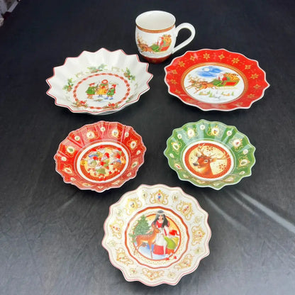 A festive porcelain mug with gold trim and santa claus scene from the decorbites christmas dinnerware set