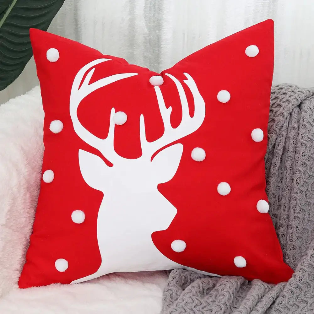 Red throw pillow cushion cover with white christmas elk embroidered silhouette and scattered white pom-poms by decorbites christmas elk