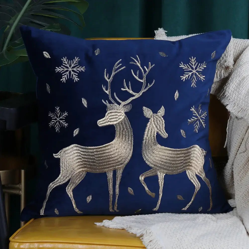 Deep blue velvet cushion cover with intricate silver and metallic thread christmas elk embroidered snowflake design by decorbites