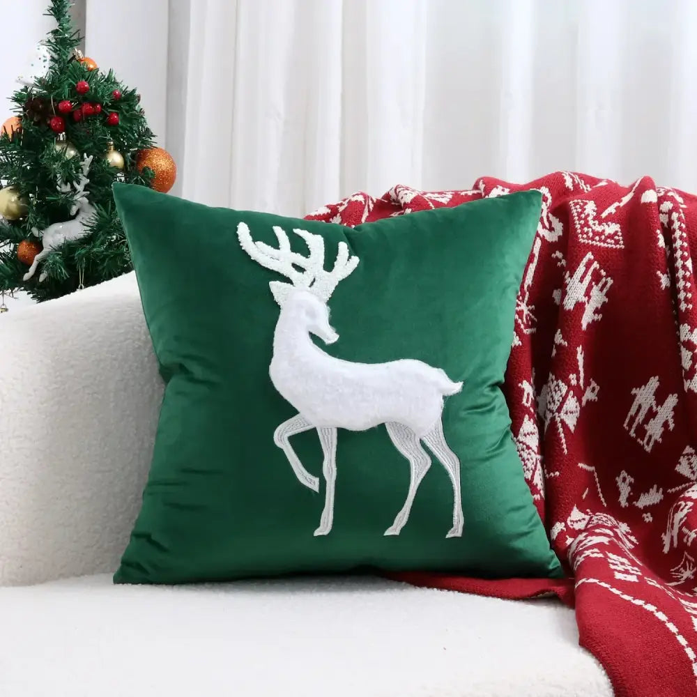 Deep green velvet pillow cover with white embroidered christmas elk design by DecorBites for festive decor