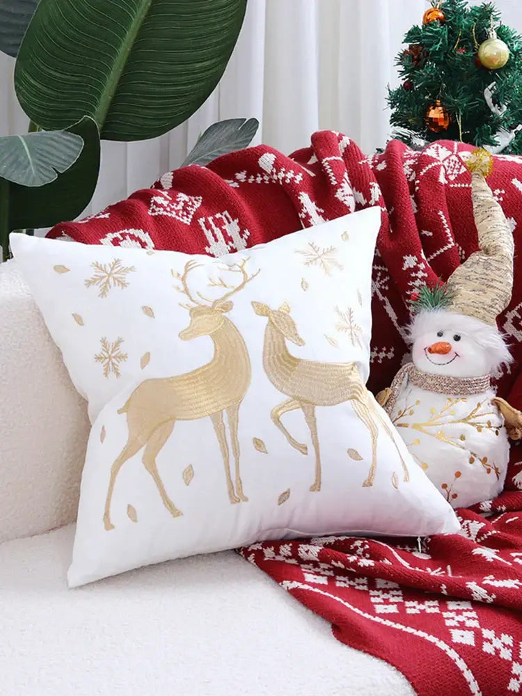 White square pillow cover with embroidered gold christmas elk and snowflake patterns from decorbites christmas elk collection
