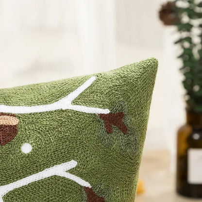 Green embroidered cushion cover with white and brown tree branch design from decorbites christmas embroidered collection