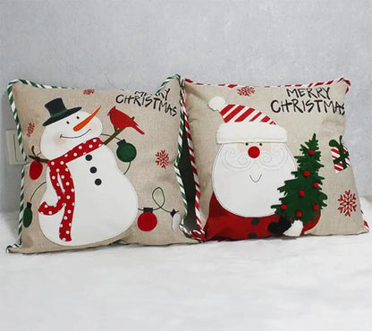 Two decorbites christmas embroidered pillowcases with snowman and santa designs on beige fabric with striped ties