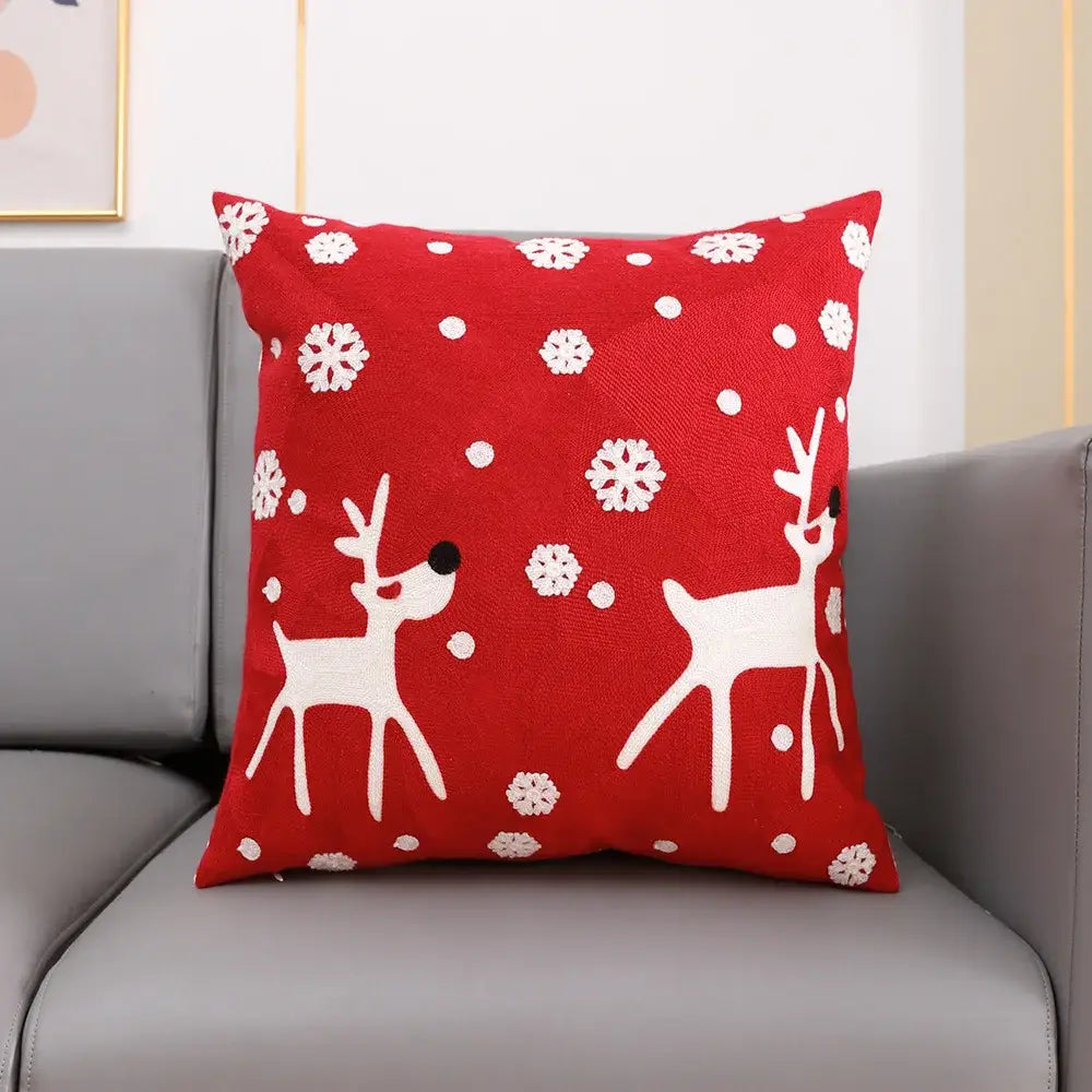 Red cushion cover with white embroidered reindeer and snowflakes from decorbites christmas embroidery collection cotton square pillowcase