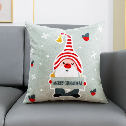 Light green cotton cushion cover with decorbites christmas embroidery featuring a striped gnome and holiday motifs