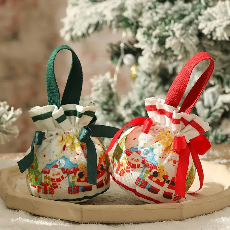 Two decorbites christmas eve festive handheld apple bags with santa designs in green and red drawstrings for gifts