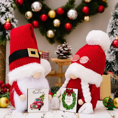 Two festive red knitted decorbites christmas gnome dolls with white fluffy beards and distinctive accessories