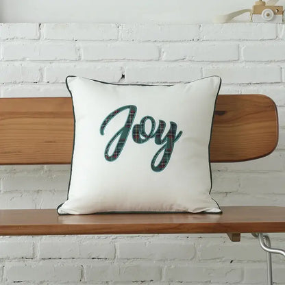 White square DecorBites christmas letter pillow with joy embroidery in green and red plaid framed by black piping