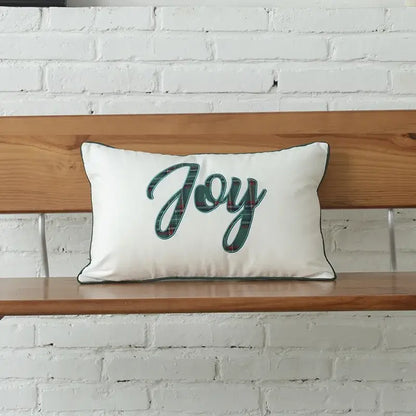 White rectangular pillow with decorbites christmas letter embroidery plaid featuring joy in green plaid script and dark piping