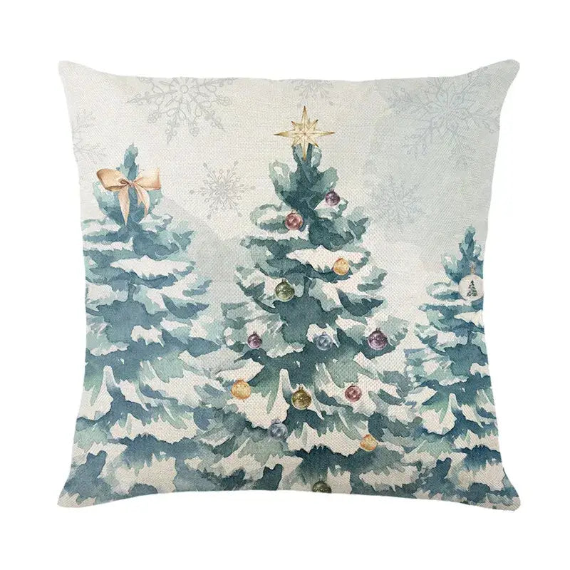 Square linen pillow cover with watercolor christmas letter print of snow-covered trees and colorful ornaments by decorbites