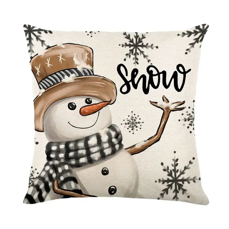 Beige linen throw pillow cover with decorbites christmas letter print featuring a snowman and black snowflake patterns