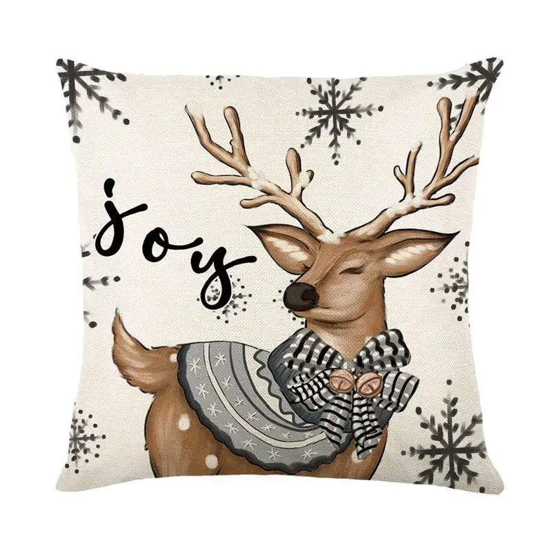 Beige linen pillow cover featuring brown deer with antlers and joy script decorbites christmas letter print design