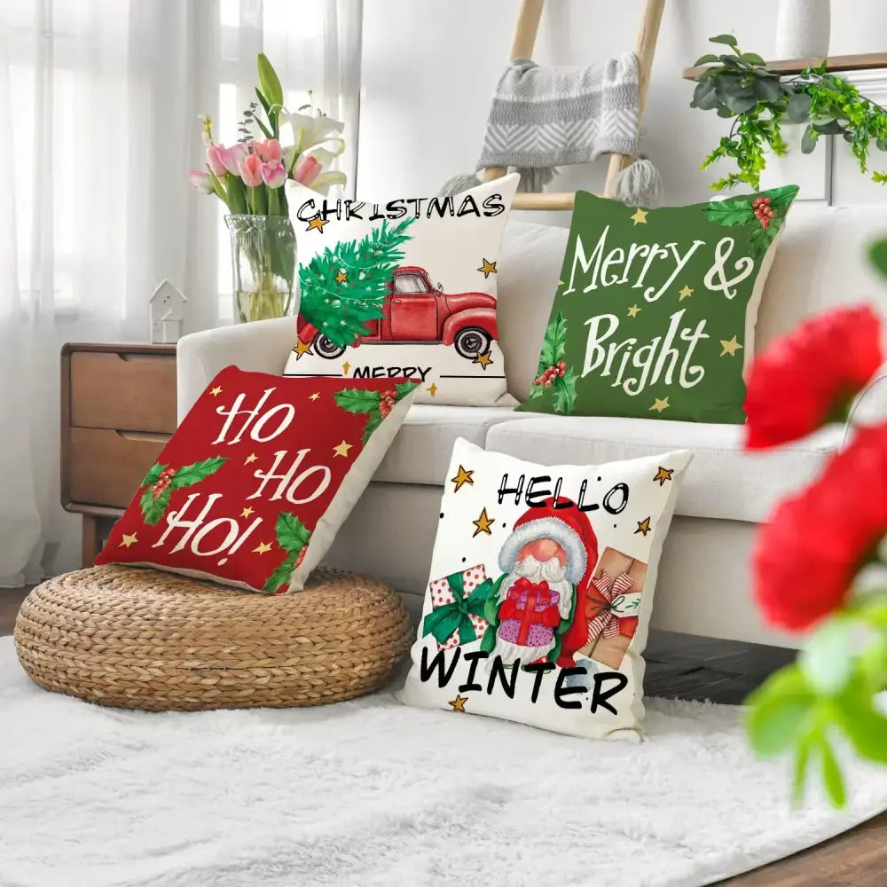 Four festive christmas linen decorative throw pillows with colorful holiday designs and text for home decor
