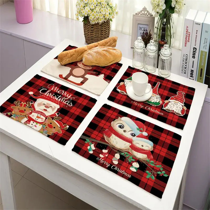 Set of four festive red and black plaid linen dining table mats with santa, reindeer, owls, and snowmen for christmas decor