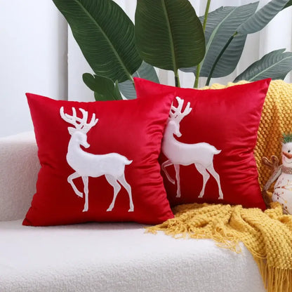 Red velvet cushion cover with white embroidered reindeer design from decorbites christmas patchwork merrychristmas collection