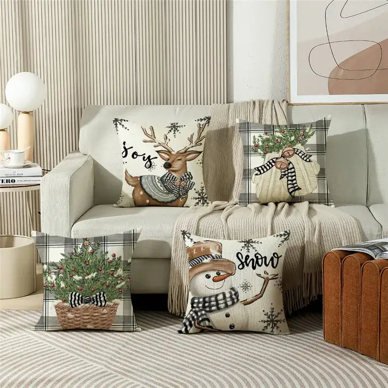 Set of four decorbites christmas pillowcase collection featuring festive reindeer snowman and plaid designs in neutral tones