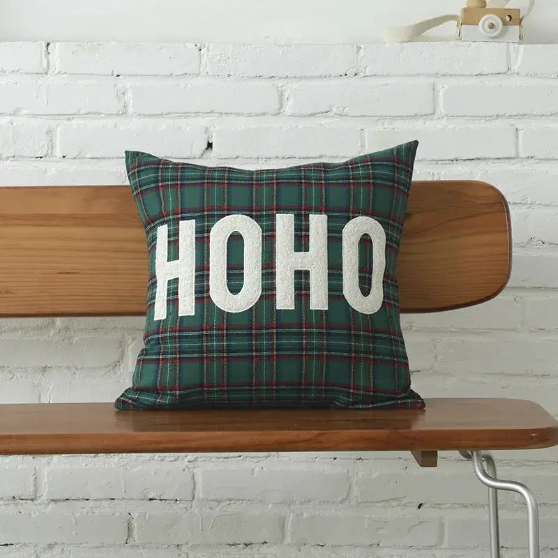 A festive green plaid cotton canvas cushion cover with bold white ho ho lettering and snowflake embroidery by DecorBites Christmas Plaid